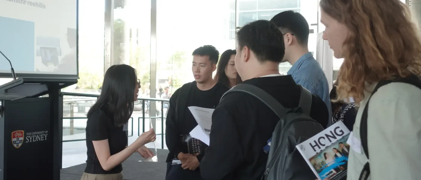 A student speaking with a firm representative at the Hong Kong Law Fair