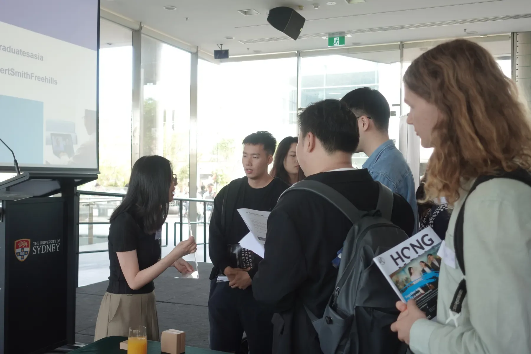 A student speaking with a firm representative at the Hong Kong Law Fair