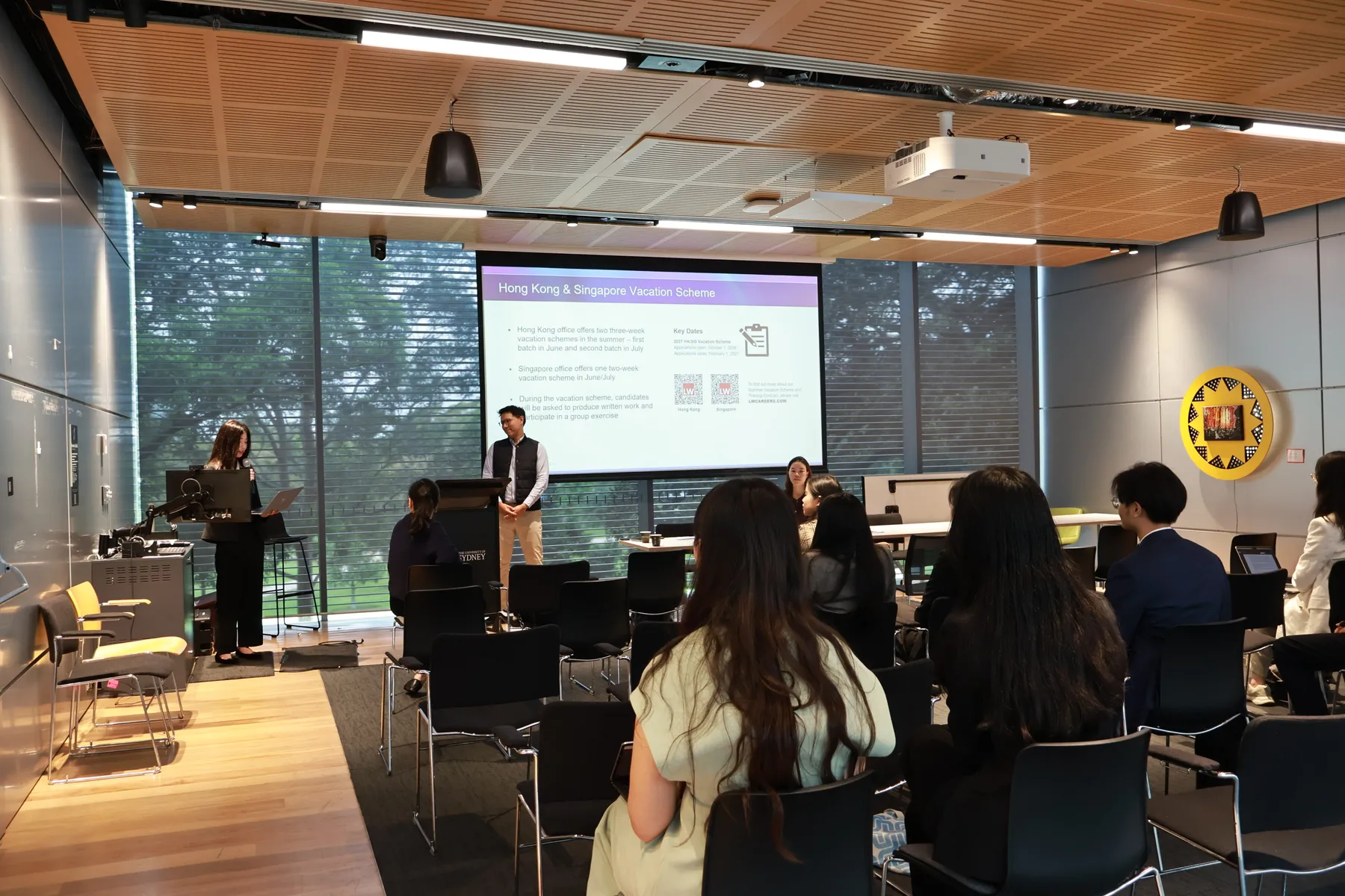 A speaker presenting to students at a CLSS education panel